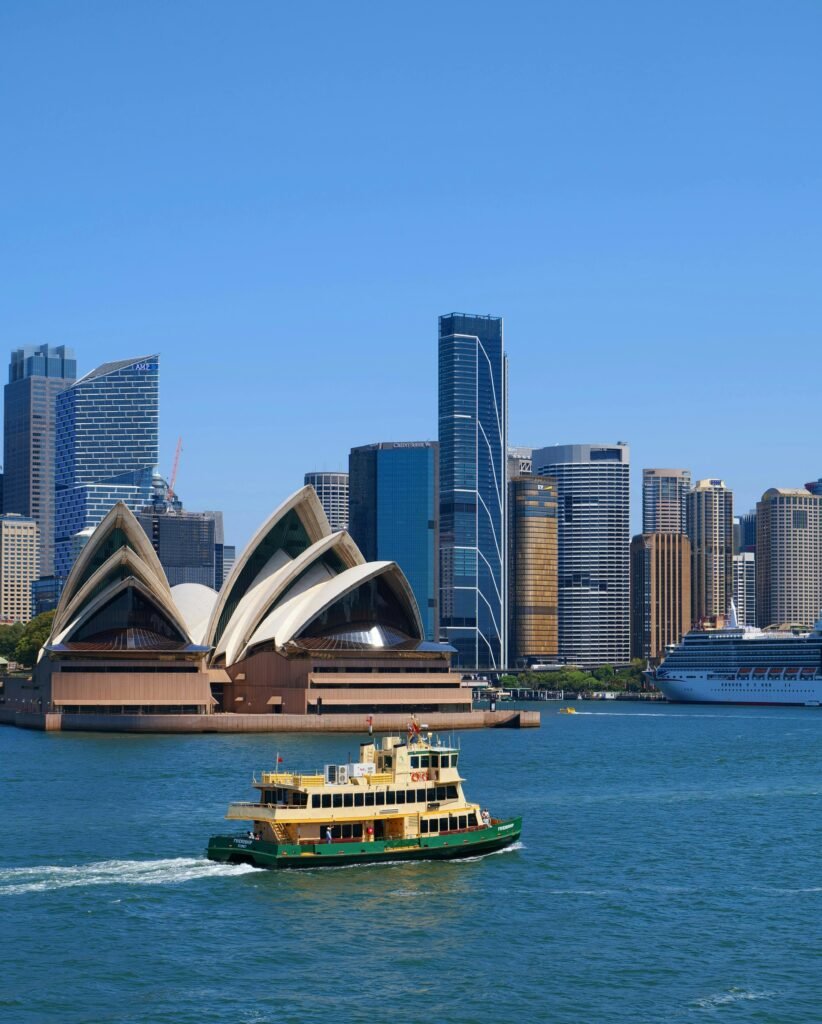 Scenic view of Sydney Opera House and ferry on a bright day, ideal for travel exploration.