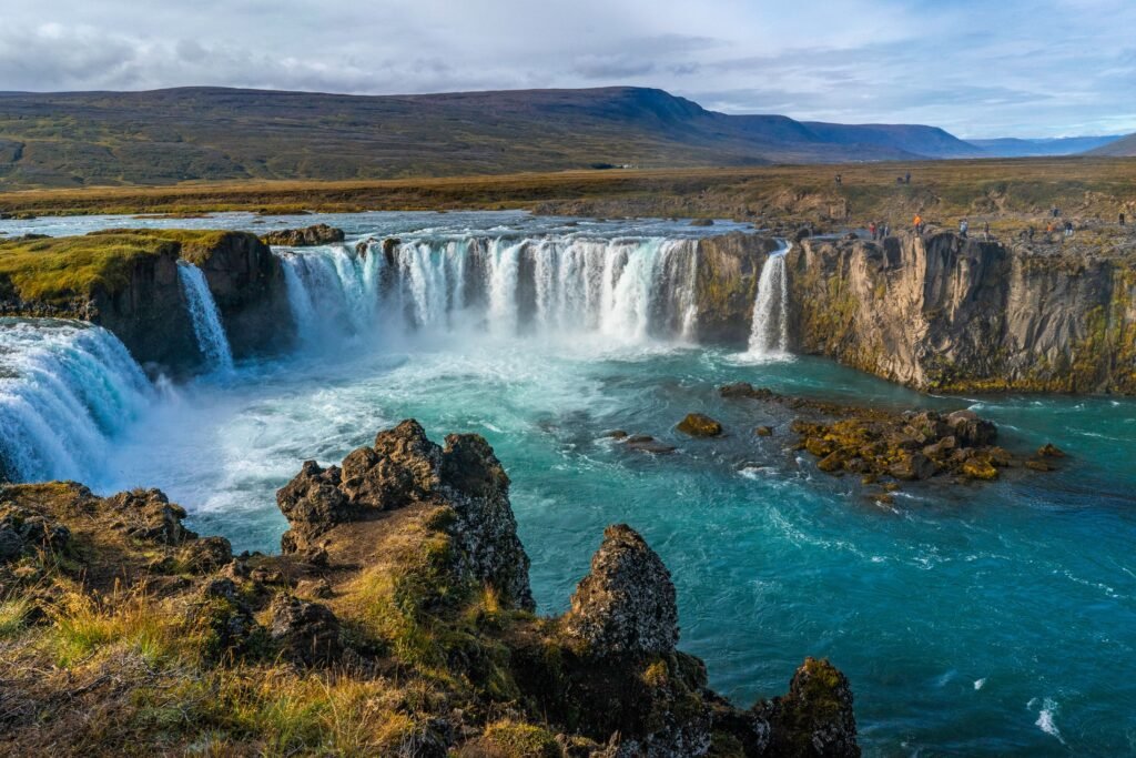 Godafoss Waterfall cascading beautifully amidst rocky terrain, showcasing Iceland's breathtaking natural scenery.