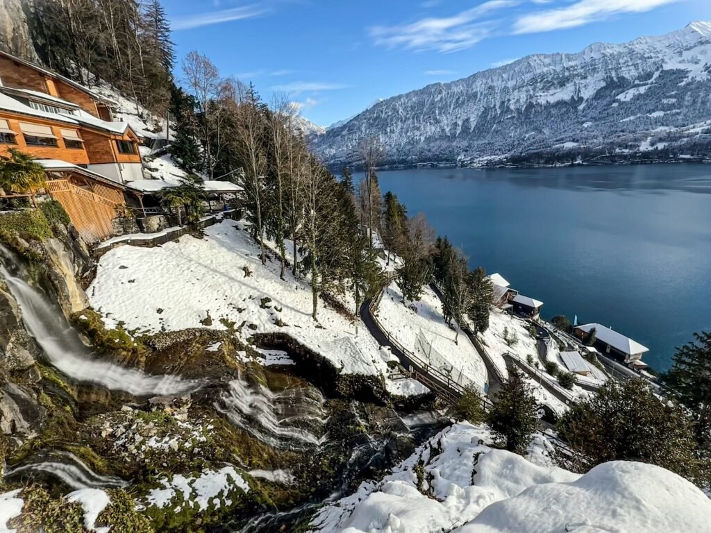 Captivating winter scene of a snow-covered alpine lake with stunning mountain views.