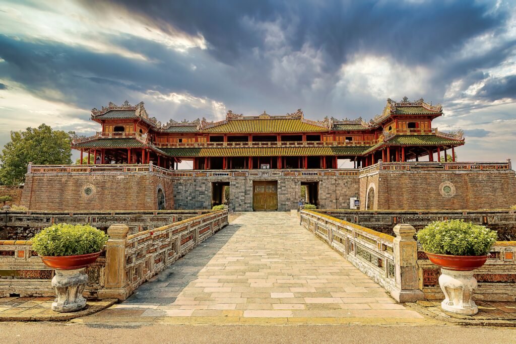 Stunning view of the Imperial City of Hue with dramatic clouds overhead, showcasing its majestic architecture.